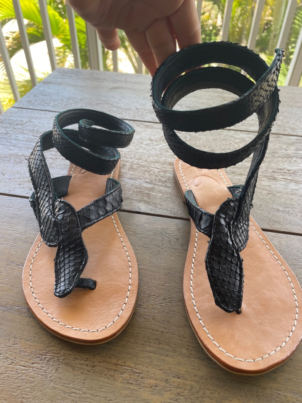 Black leather flat sandals  python snake-embossed  and wraparound ankle strap.